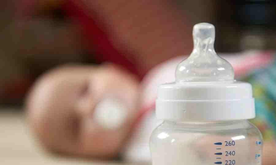 Baby and bottle scale in focus